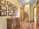 Hallway with hardwood floors, wooden staircase, and framed photographs lining the wall at 33121 Lynx Ln, Evergreen, CO 80439