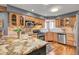 Well-appointed kitchen featuring wood cabinets, granite countertops, and stainless steel appliances at 33121 Lynx Ln, Evergreen, CO 80439