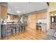 Open kitchen with breakfast bar, light wood cabinets, stainless steel appliances, and hardwood floors at 33121 Lynx Ln, Evergreen, CO 80439