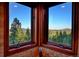 Kitchen nook offering scenic views of the outside through a large corner window at 33121 Lynx Ln, Evergreen, CO 80439