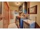 This charming laundry room features a washer, dryer, utility sink, and custom cabinets for optimal storage at 33121 Lynx Ln, Evergreen, CO 80439