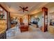 Spacious living room featuring a large sofa, built-in shelves, ceiling fan and access to the outdoors at 33121 Lynx Ln, Evergreen, CO 80439