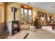 This comfortable living area includes a cozy fireplace, a bay window with natural light, and access to the outside at 33121 Lynx Ln, Evergreen, CO 80439