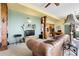 Inviting living room featuring a cozy leather sofa and an adjacent office space with custom wood built-ins at 33121 Lynx Ln, Evergreen, CO 80439