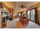 Comfortable living room area with stone fireplace, a large sofa, and natural lighting at 33121 Lynx Ln, Evergreen, CO 80439