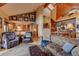 Bright and open living room with vaulted ceilings, wood floors, and seamless flow to the kitchen at 33121 Lynx Ln, Evergreen, CO 80439