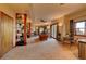 A finished basement features a living area with a wood-burning stove, floor-to-ceiling shelves, and outside access at 33121 Lynx Ln, Evergreen, CO 80439