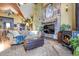 Inviting living room featuring a stone fireplace, wood stove, and comfortable seating at 33121 Lynx Ln, Evergreen, CO 80439