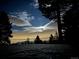 Scenic night view featuring silhouetted trees against a starlit sky with glowing clouds, a tranquil landscape at 33121 Lynx Ln, Evergreen, CO 80439