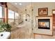 Luxury shower with fireplace and window with nature views at 33121 Lynx Ln, Evergreen, CO 80439