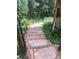 Rustic stone steps winding through lush greenery, complemented by vibrant flowers and natural wood accents at 33121 Lynx Ln, Evergreen, CO 80439