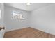 Light-filled bedroom featuring wood floors and a window at 6051 Welch St, Arvada, CO 80004