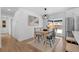 Dining area with light wood table and black chairs, near kitchen at 6051 Welch St, Arvada, CO 80004