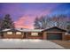 Brick ranch home with a landscaped yard and attached garage at 6051 Welch St, Arvada, CO 80004