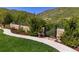 Serene backyard with lush landscaping, gated entrance, and views at 7767 Dante Dr, Littleton, CO 80125