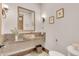 Stylish powder room featuring decorative sink, granite counters and a framed mirror at 7767 Dante Dr, Littleton, CO 80125