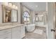 Luxurious bathroom with dual vanities, soaking tub, and large window with scenic views at 7767 Dante Dr, Littleton, CO 80125