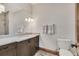 Clean bathroom with modern vanity, toilet, shower with stylish tiles and updated fixtures at 7767 Dante Dr, Littleton, CO 80125