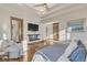 Spacious bedroom featuring a fireplace, tv, and a cozy reading nook at 7767 Dante Dr, Littleton, CO 80125