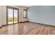 Bright bedroom with hardwood floors, sliding glass door, and large windows to let in natural light at 7767 Dante Dr, Littleton, CO 80125