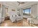 Bright bedroom with tray ceiling, scenic views from windows, and hardwood floors at 7767 Dante Dr, Littleton, CO 80125
