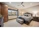 Comfortable bedroom with neutral tones, wooden bed frame, and a window overlooking a garden at 7767 Dante Dr, Littleton, CO 80125