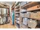 Walk-in closet with custom wood shelving, storage baskets, and ample space at 7767 Dante Dr, Littleton, CO 80125