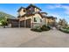 Spacious stucco and stone home boasting a three-car garage and a well-manicured front yard under a blue sky at 7767 Dante Dr, Littleton, CO 80125