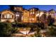 Beautiful stucco and stone home featuring manicured landscaping and a cozy front patio with a fire pit at 7767 Dante Dr, Littleton, CO 80125