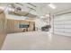 Well-organized garage featuring ample storage, custom cabinets, epoxy flooring and high ceilings at 7767 Dante Dr, Littleton, CO 80125