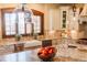 Well-lit kitchen features granite countertops, stainless steel appliances, and a farmhouse sink at 7767 Dante Dr, Littleton, CO 80125