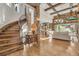 Bright and spacious living room featuring wood floors, exposed beams, and stone accents with seamless outdoor access at 7767 Dante Dr, Littleton, CO 80125