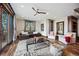Bright living room with leather sectional sofa, plush rug, and access to the outdoor balcony at 7767 Dante Dr, Littleton, CO 80125
