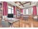 Bright office space with hardwood floors, custom built-in shelving, and wooden ceiling beams at 7767 Dante Dr, Littleton, CO 80125