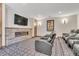 Cozy home theater featuring a stone fireplace and wall-mounted television for entertainment at 7767 Dante Dr, Littleton, CO 80125