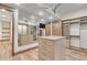 Spacious walk-in closet with custom shelving, drawers, central cabinet, and a full-length mirror at 7767 Dante Dr, Littleton, CO 80125