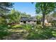 Scenic backyard featuring a lush lawn, mature trees, and stone landscaping at 6700 W 80Th Cir, Arvada, CO 80003