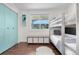 Bedroom showcasing a bunk bed, a window view, aqua-colored closet doors, and storage solutions at 6700 W 80Th Cir, Arvada, CO 80003