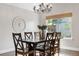 A lovely dining room with a large wooden table, stylish chairs, and natural light, perfect for Gathering meals at 6700 W 80Th Cir, Arvada, CO 80003