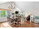 A dining room showcasing seamless access to the living room and filled with natural light from the large windows at 6700 W 80Th Cir, Arvada, CO 80003