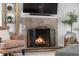 The fireplace features a decorative screen, stone surround, and a large television above, adding a modern touch at 6700 W 80Th Cir, Arvada, CO 80003