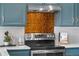 Close up of kitchen with stainless steel range and custom tile backsplash at 6700 W 80Th Cir, Arvada, CO 80003