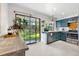 Bright kitchen featuring stainless steel appliances, custom blue cabinets, and access to the backyard at 6700 W 80Th Cir, Arvada, CO 80003