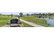 Scenic view of Lake Arbor Park with walking path, green spaces, and a calm lake at 6700 W 80Th Cir, Arvada, CO 80003