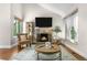 The living room features a stone fireplace, large window, and stylish decor for a cozy and inviting atmosphere at 6700 W 80Th Cir, Arvada, CO 80003