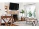 This living room features a fireplace, window, and is adjacent to the dining area for easy entertaining at 6700 W 80Th Cir, Arvada, CO 80003
