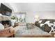 A spacious living room that features a cozy fireplace, ample seating, and natural light at 6700 W 80Th Cir, Arvada, CO 80003