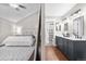 Spacious main suite with large bed, bright bathroom, and wood floors at 6700 W 80Th Cir, Arvada, CO 80003