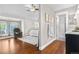 Spacious main suite with large bed, bright bathroom, and wood floors at 6700 W 80Th Cir, Arvada, CO 80003