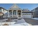 Gray two-story house with white trim, a front porch, and a two-car garage at 565 Twilight St, Erie, CO 80516